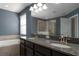 An inviting Primary bathroom featuring double vanity with granite countertop, tub and glass shower stall at 4146 Bexley Village Dr, Land O Lakes, FL 34638