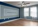 A modern bedroom featuring neutral color schemes, sleek ceiling fan, and large windows at 4146 Bexley Village Dr, Land O Lakes, FL 34638