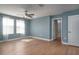 Spacious bedroom with hardwood flooring, large windows with coverings, and a neutral colored walls at 4146 Bexley Village Dr, Land O Lakes, FL 34638