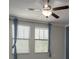 Cozy bedroom with ceiling fan, large windows with coverings, and neutral colored walls at 4146 Bexley Village Dr, Land O Lakes, FL 34638
