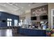 A cafe with sleek counter space, hanging lights, and a decorative brick wall with the 