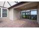 Spacious covered patio with brick flooring and screened enclosure at 4146 Bexley Village Dr, Land O Lakes, FL 34638