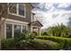 Charming home exterior with manicured green shrubs, offering a glimpse of a two-story structure and well-maintained facade at 4146 Bexley Village Dr, Land O Lakes, FL 34638