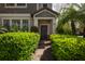 Inviting home entrance with lush green bushes leading to the front door and showcasing the house number at 4146 Bexley Village Dr, Land O Lakes, FL 34638
