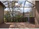Screened patio with brick flooring overlooking the backyard at 4146 Bexley Village Dr, Land O Lakes, FL 34638