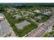 An aerial view reveals an apartment complex surrounded by lush green trees with city in the background at 4207 S Dale Mabry Hwy # 8304, Tampa, FL 33611