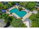 Overhead view of community pool surrounded by lounge chairs, tropical plants and gazebos at 4207 S Dale Mabry Hwy # 8304, Tampa, FL 33611
