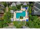 Aerial view of pool area with lounge chairs, tropical landscaping and outdoor gazebos at 4207 S Dale Mabry Hwy # 8304, Tampa, FL 33611