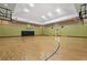 Spacious indoor basketball court with wood flooring, hoops and doors leading outside at 4207 S Dale Mabry Hwy # 8304, Tampa, FL 33611