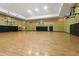 Large indoor basketball court with wood flooring, basketball hoops and doors leading to hallway at 4207 S Dale Mabry Hwy # 8304, Tampa, FL 33611