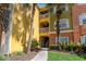 Condo building with multiple levels featuring colorful facades, tropical landscaping, and walkways at 4207 S Dale Mabry Hwy # 8304, Tampa, FL 33611