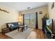 Living room with hardwood floors, comfortable couch, and a large window for natural light at 4207 S Dale Mabry Hwy # 8304, Tampa, FL 33611