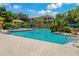 Community pool area with lounge chairs, tropical landscaping, and inviting blue water at 4207 S Dale Mabry Hwy # 8304, Tampa, FL 33611