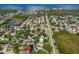 Aerial view showcasing the property's location in a community setting, highlighting the waterfront and the home's pool at 428 Klosterman W Rd, Palm Harbor, FL 34683