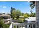 A view of the backyard, a neighborhood and trees beyond at 428 Klosterman W Rd, Palm Harbor, FL 34683