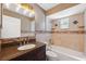 An updated bathroom features tile walls, a modern vanity, and a shower-tub combo at 428 Klosterman W Rd, Palm Harbor, FL 34683