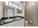 Bathroom features a double sink vanity with a granite countertop and white cabinets at 428 Klosterman W Rd, Palm Harbor, FL 34683
