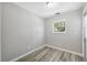 Bedroom has light gray walls, wood floors and a large window at 428 Klosterman W Rd, Palm Harbor, FL 34683