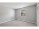 A bedroom with carpet and a large window for natural light at 428 Klosterman W Rd, Palm Harbor, FL 34683