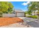 Attached two-car garage featuring stone accents, a white door, and a spacious driveway at 428 Klosterman W Rd, Palm Harbor, FL 34683