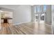 Well-lit living room with access to the eat-in kitchen, large windows, and wood flooring at 428 Klosterman W Rd, Palm Harbor, FL 34683
