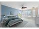 Spacious main bedroom features a light blue accent wall, balcony access and large windows at 428 Klosterman W Rd, Palm Harbor, FL 34683