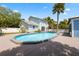 A backyard swimming pool with a deck and a view of the house at 428 Klosterman W Rd, Palm Harbor, FL 34683