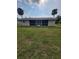 View of the backyard with tropical landscaping at 474 Hinton St, Port Charlotte, FL 33954