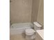 Bathroom featuring a tiled shower/tub combo and toilet at 474 Hinton St, Port Charlotte, FL 33954