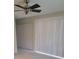 Bedroom with a ceiling fan, light colored walls, and a closet for storage at 474 Hinton St, Port Charlotte, FL 33954