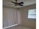 Bedroom featuring sliding glass door, a ceiling fan, and light colored walls at 474 Hinton St, Port Charlotte, FL 33954