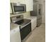 The kitchen is equipped with stainless steel appliances and granite countertops at 474 Hinton St, Port Charlotte, FL 33954