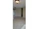 Bright living room featuring neutral tile flooring, light colored walls, and access to outdoor living spaces at 474 Hinton St, Port Charlotte, FL 33954