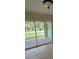 The sunroom is enclosed with sliding glass doors and tiled floors at 474 Hinton St, Port Charlotte, FL 33954