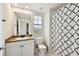 Neat bathroom featuring granite countertop, white cabinetry, and modern shower curtain at 504 S Armenia Ave # 1329B, Tampa, FL 33609