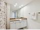 Bright bathroom with granite countertop, white cabinetry, and spacious vanity mirror at 504 S Armenia Ave # 1329B, Tampa, FL 33609