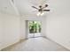 Cozy bedroom with neutral carpet, ceiling fan, and sliding glass door to outdoor patio at 504 S Armenia Ave # 1329B, Tampa, FL 33609
