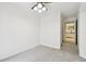 Bright bedroom featuring neutral carpet, ceiling fan with lighting, and view of bathroom at 504 S Armenia Ave # 1329B, Tampa, FL 33609