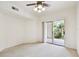 Comfortable bedroom with neutral carpet, ceiling fan, and glass doors to an outdoor patio at 504 S Armenia Ave # 1329B, Tampa, FL 33609