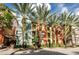 Beautiful building facade with palm trees, colorful paint, multiple windows, and balcony views at 504 S Armenia Ave # 1329B, Tampa, FL 33609