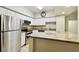 Well-lit kitchen featuring white cabinets, stainless steel appliances, and speckled granite countertops at 504 S Armenia Ave # 1329B, Tampa, FL 33609