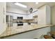 Modern kitchen boasts stainless appliances, granite counters, a breakfast bar, and tile flooring at 504 S Armenia Ave # 1329B, Tampa, FL 33609