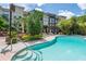 Community pool with sun loungers, landscaped grounds and access steps, against a backdrop of residential buildings at 504 S Armenia Ave # 1329B, Tampa, FL 33609