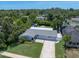 Aerial view of a well-maintained home with a large backyard and lush landscaping, showcasing its curb appeal at 5044 17Th N St, St Petersburg, FL 33714