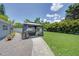 Landscaped backyard features an outdoor lounge area with a gazebo and lush lawn for relaxation and enjoyment at 5044 17Th N St, St Petersburg, FL 33714