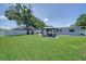 Expansive backyard featuring a gazebo, lush lawn, and mature trees, ideal for relaxation and outdoor activities at 5044 17Th N St, St Petersburg, FL 33714