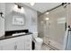 Modern bathroom with dark countertops, tiled shower, and elegant fixtures, creating a spa-like retreat at 5044 17Th N St, St Petersburg, FL 33714