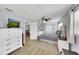 Bright bedroom features a ceiling fan, light wood floors, and white furnishings creating a relaxing atmosphere at 5044 17Th N St, St Petersburg, FL 33714