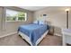 Guest bedroom featuring carpeted floors, a window with natural light, and a double bed with patterned bedding at 5044 17Th N St, St Petersburg, FL 33714