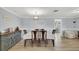 Cozy dining room featuring a blue accent wall, striped table cloth, and modern decor, with ample natural light at 5044 17Th N St, St Petersburg, FL 33714